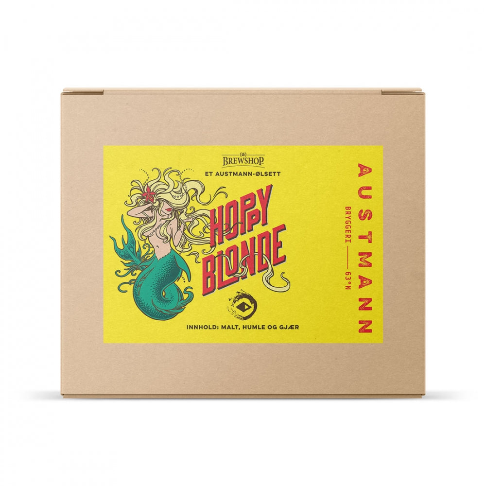 En pappeske med en gul etikett med en havfrue og teksten "Austmann Hoppy Blonde - allgrain ølsett" fra Brewshop; dette settet brygger en belgisk blond ale med malt, humle og gjær.