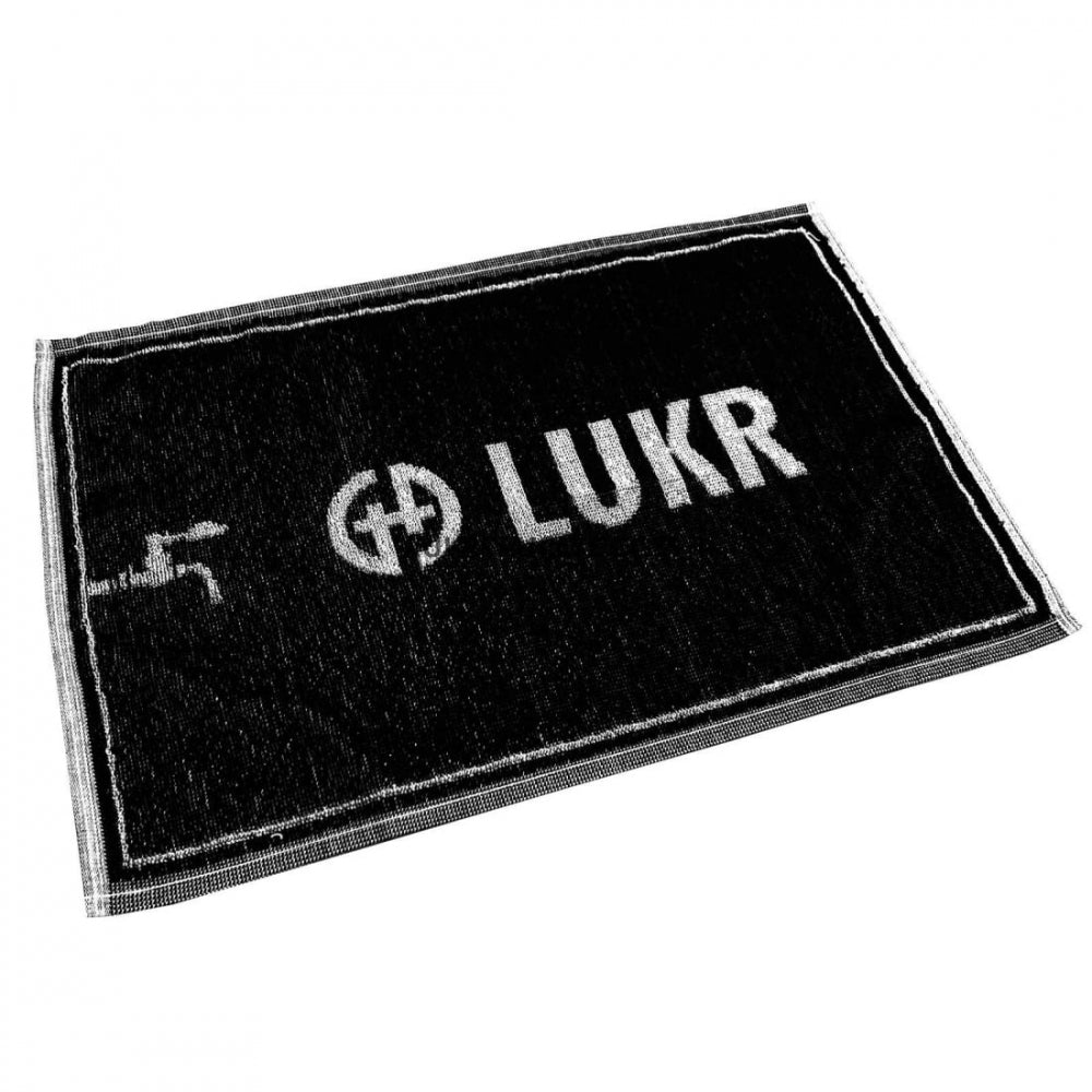 LUKR Bar Towel fra Lukr er en svart rektangulær bomullsdørmatte på 50x30 cm med en hvit kant, med "LUKR" og en sentral logo - perfekt som et unikt barhåndkle eller som en stilig aksent i inngangspartiet.