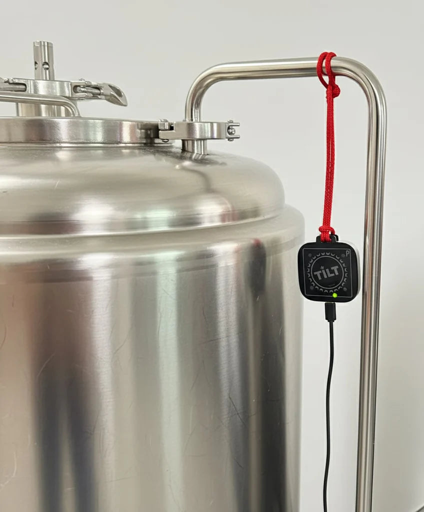 En gjæringstank i rustfritt stål har et Tilt Hydrometer koblet til Tilt Pico - WiFi-adapteren med en rød ledning for automatisk WiFi-logging og sømløs overvåking, samtidig som den lades via kabel. Merkevare: Tilt Hydrometer.