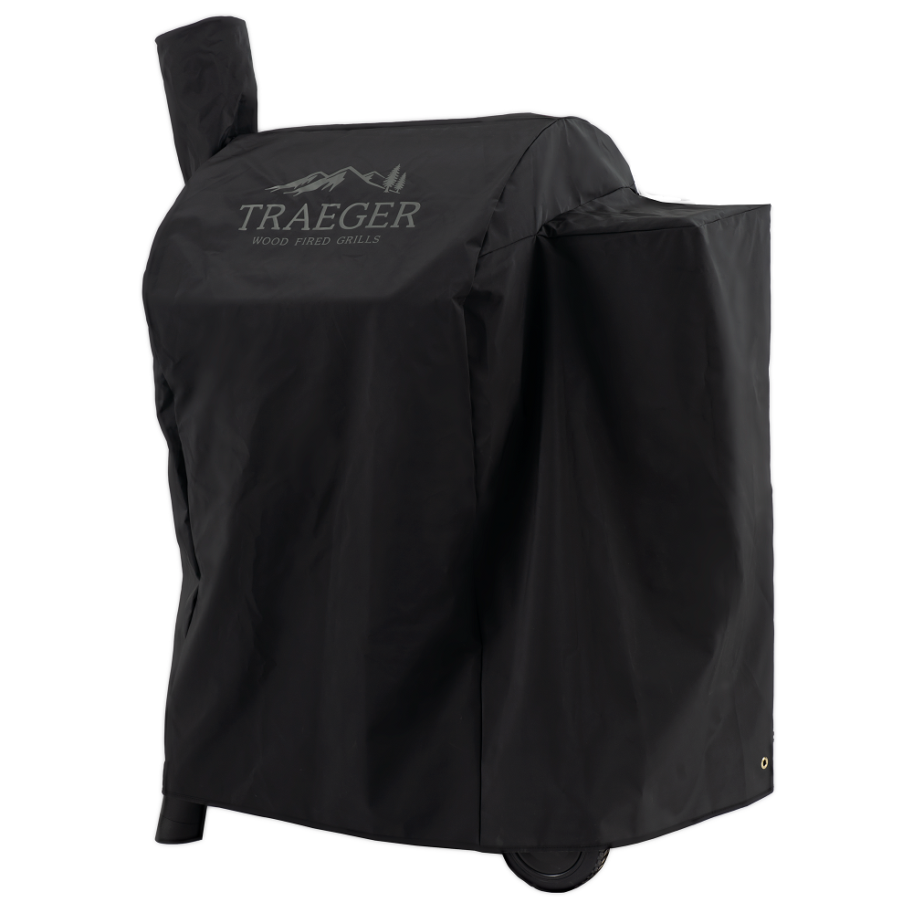 Traeger Pro 575 D2 / Pro 22 Cover - Grilltrekk er et værbestandig grilltrekk med Traeger-logo, som dekker Traeger-grillen din samtidig som hjulene er delvis synlige.