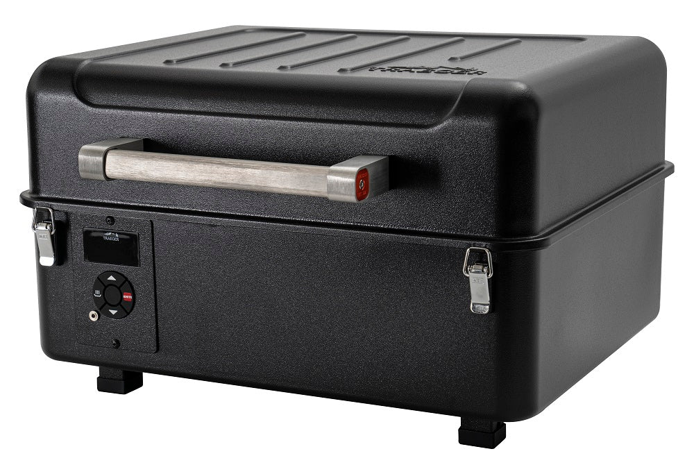Traeger Ranger mobil pelletsgrill er en svart, rektangulær bordgrill med trehåndtak, metallspenner og kontrollknapp foran, avbildet mot en hvit bakgrunn.