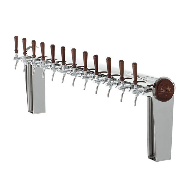Lindr Naked Cold Bridge 12 Tappetårn er et øltappesystem i rustfritt stål med tolv trehåndtak plassert på rad, montert på to solide ben. Det elegante tappetårn-designet er utstyrt med Cold Bridge-kjøling for optimal serveringstemperatur.