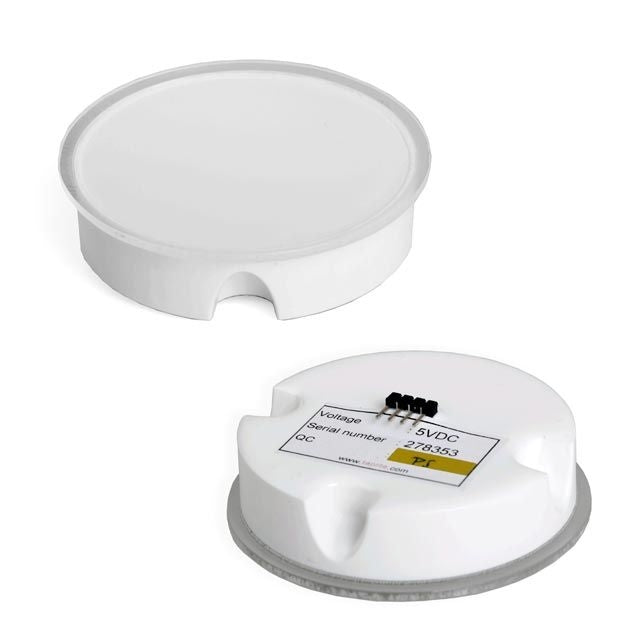To hvite, runde Lindr Taplite-medaljonger (flate, diameter 69 mm); den ene viser den glatte toppen, mens den andre viser bunnen med en etikett for spenning, serienummer og kontakt.