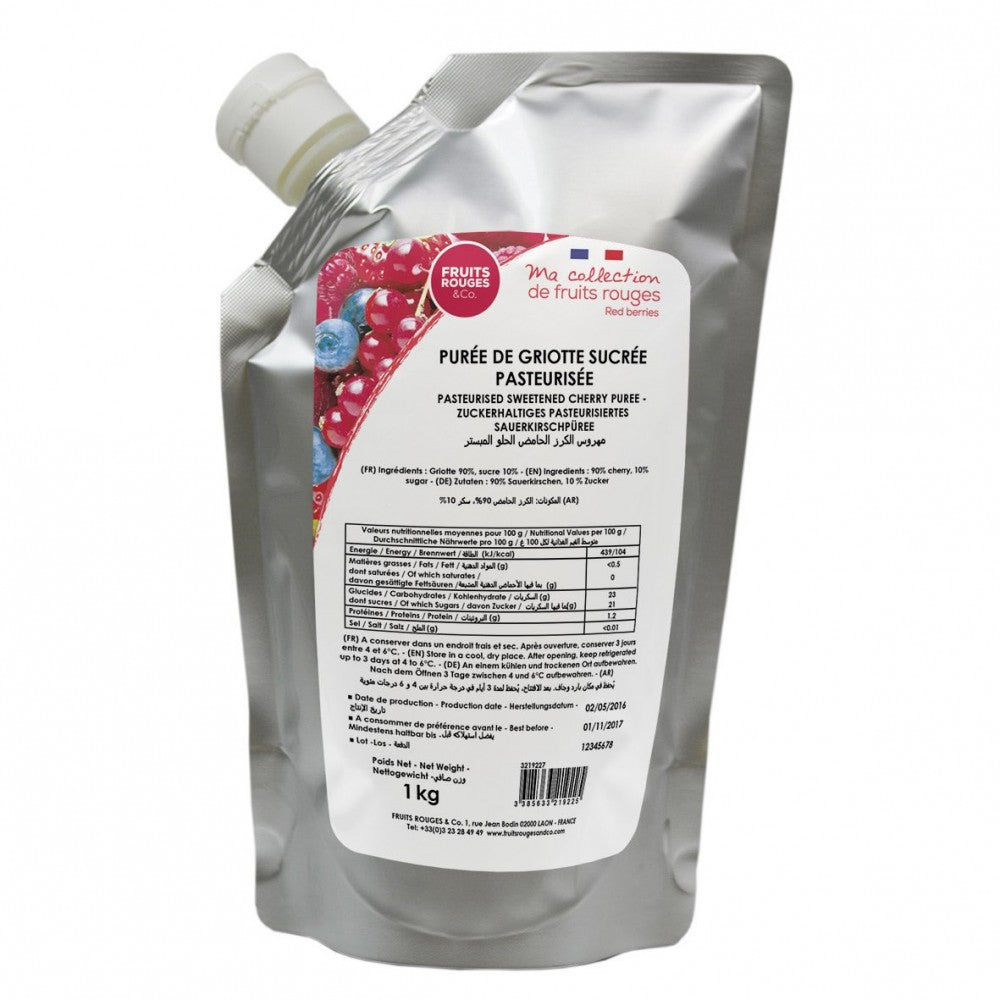 En 1 kg sølvpose med pasteurisert, søtet Kirsebærpuré fra Fruits Rouges & Co, med hvitt lokk og etikett på fransk, engelsk, tysk og arabisk.