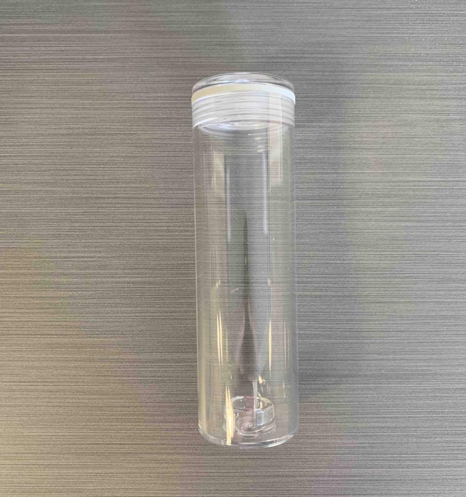 Replacement Tube Tilt V3 (ny versjon) fra Tilt Hydrometer, et gjennomsiktig plastglass med hvitt lokk, er vist stående på en strukturert, lysegrå overflate.