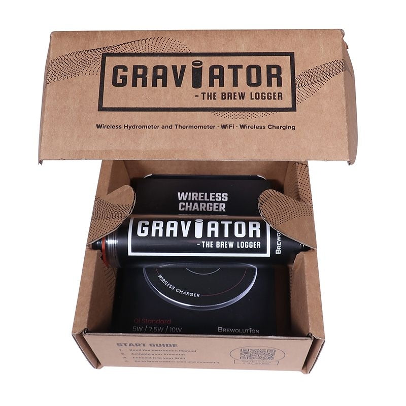 En åpen pappeske inneholder et Brewolution Graviator - WiFi hydrometer og termometer-sett, som viser enheten og en trådløs lader inni.