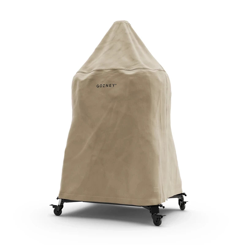 Et Gozney Dome Cover Gen 2 trekk, langt, gir helårsbeskyttelse til din utendørs ovn eller grill på hjul - perfekt for å dekke og beskytte kjøkkenutstyret i hagen.