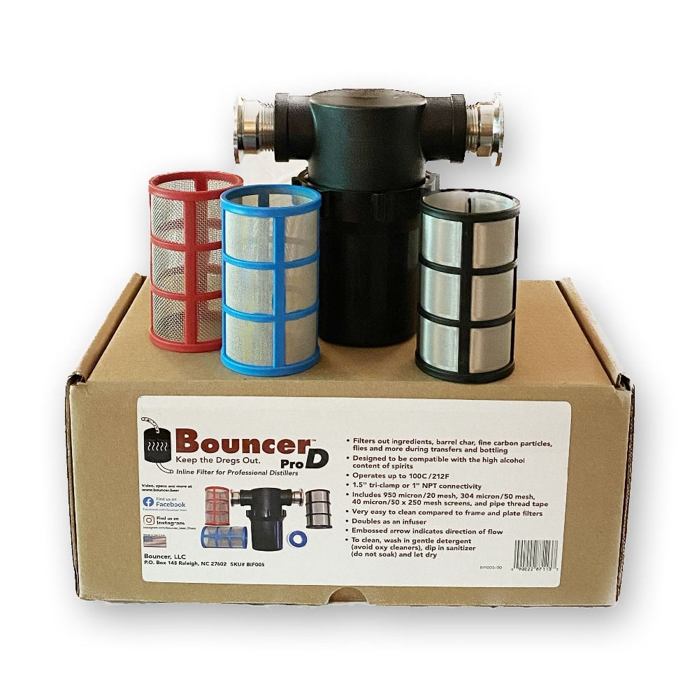 Tre metallnettfiltre og et svart filterhus for Bouncer Pro D Inline Filter 1,5" TC fra Bouncer er vist på toppen av en merket eske, ideell for destillering av brennevin.